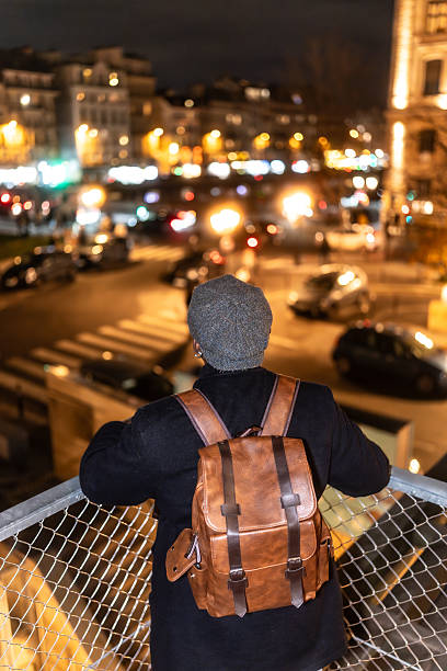 istock Traveler with backpack enjoying city night lights in paris 2250658716