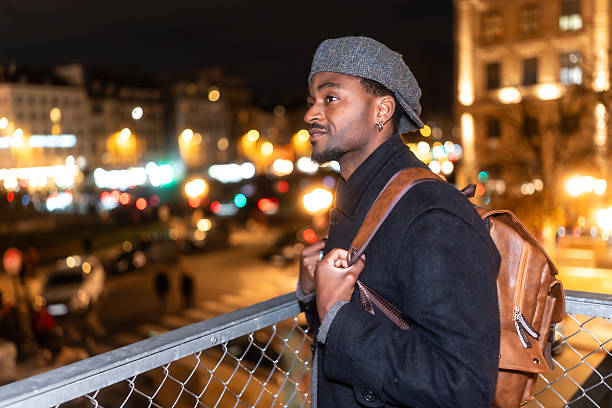 istock Young black man traveling in paris at night 2250658756