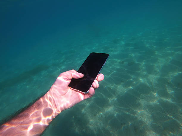 istock A hand holds a smartphone underwater in clear, sunlit sea 2250658908
