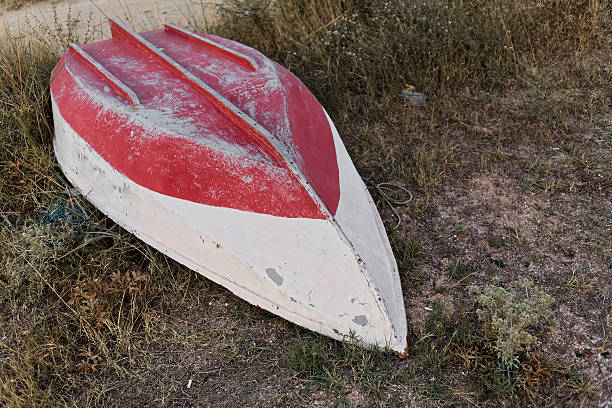 istock Abandoned Red and White Canoe in Dry Grass with Peeling Paint 2250660186