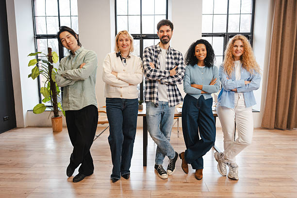istock Diverse business team standing confidently in modern office during workday 2250663555