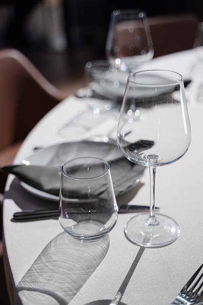 istock Elegant dining table setting with glassware, cutlery, and soft lighting for a sophisticated atmosphere 2250666380