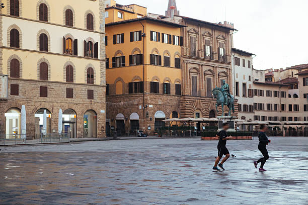 People jogging early morning in historical center of Florence