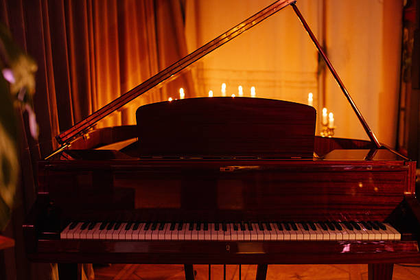 istock Grand piano with open lid illuminated by warm candlelight in an elegant setting 2250667713