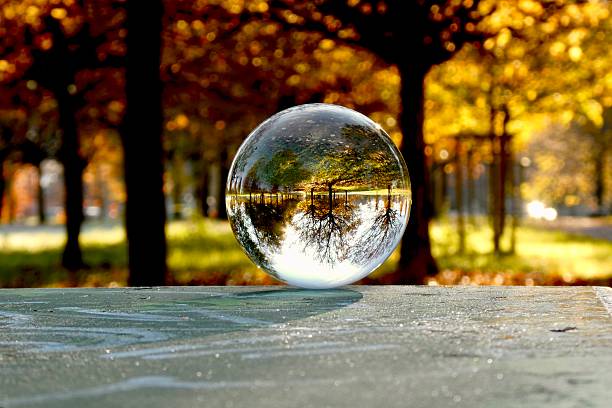 Crystal ball on frozen bench in park during autumn