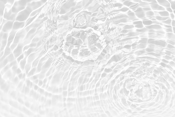 istock White water with ripples on the surface. Defocus blurred transparent white colored clear calm water surface texture with splashes and bubbles. Water waves with shining pattern texture background. 2250669449