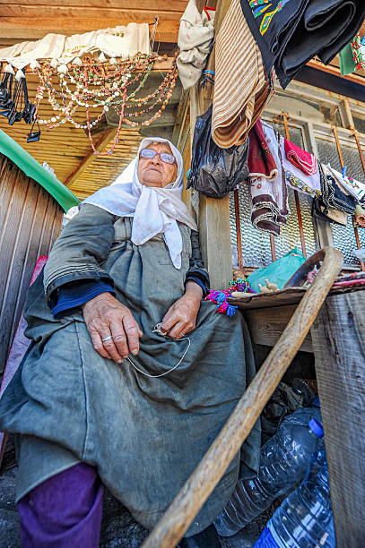 Behramkale - Çanakkale, Türkiye - August 08, 2011 : An old woman selling souvenirs in Behramkale