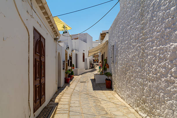 istock Sunny Whitewashed Tight Alley With Traditional Architecture And Stone Pathway In Mediterranean Village. Greece Travel Scene 2250670176