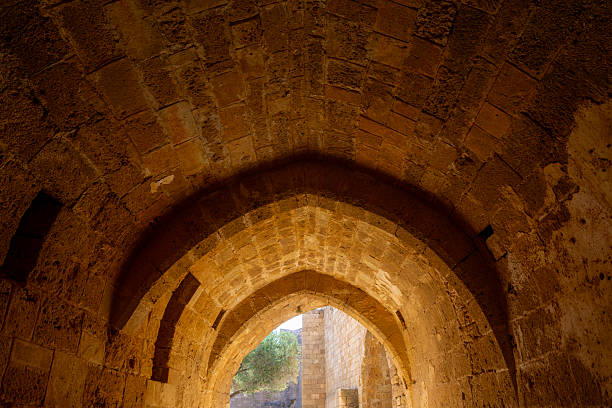 Stone Vaulted Passageway Illuminated With Warm Light Emphasizing Ancient Architecture, Historic Craftsmanship And Cultural Heritage Interior Detail.
