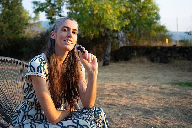 istock Woman recording podcast interview outdoors at sunset 2250674204
