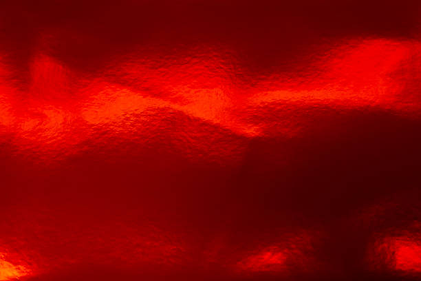 Lunar New Year. Shiny red lacquer texture with light reflections.Abstract Red Foil Texture Background. glare on a red surface.Red Metallic Foil Texture Background. Red festive background.