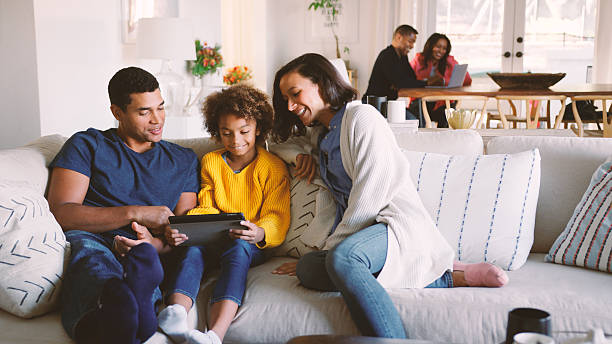 istock Multi Generation Family At Home With Parents And Daughter Using Digital Tablet In Foreground 2250674956