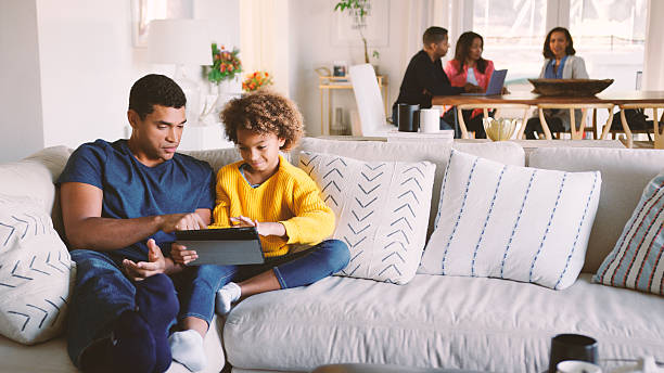 istock Multi Generation Family At Home With Father And Daughter Using Digital Tablet In Foreground 2250674967