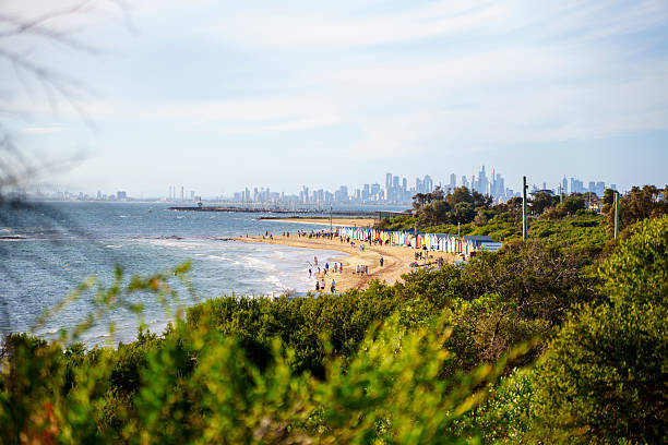 MELBOURNE, AUSTRALIA - MARCH 8 2025: The iconic and famous Brighton Beach with its stylish beach bathing boxes on a warm autumn evening in Melbourne, Victoria, Australia