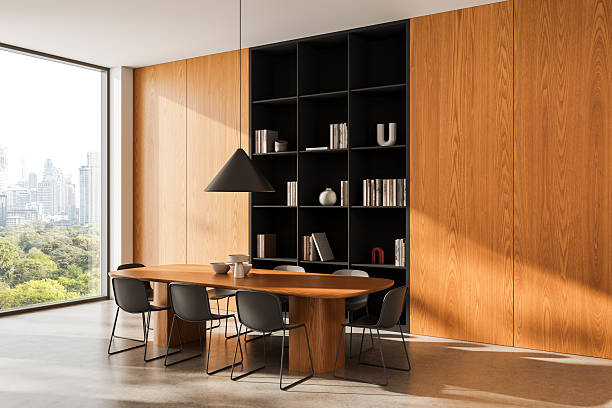 istock Modern interior design with wooden dining table, minimalist chairs, and built-in bookshelf in cozy meeting room with city view window. 3D Rendering. 3D Rendering 2250677650