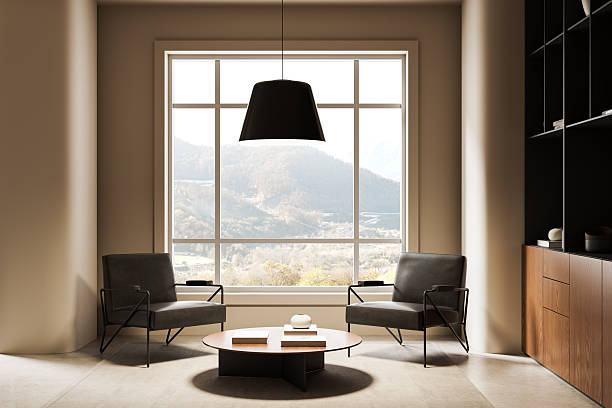 Contemporary interior with two armchairs, round coffee table, and large window showing mountain view, neutral tones and minimal design. 3D Rendering