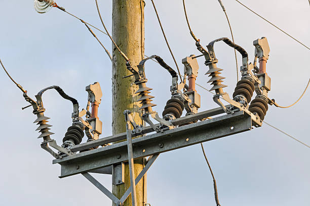istock Close-up of electrical switchgear and insulators on wooden utility pole 2250677654