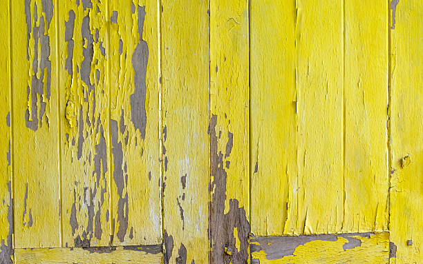 istock Peeling yellow painted wood texture with rustic, vintage charm. Ideal as a warm retro background or design element 2250678104
