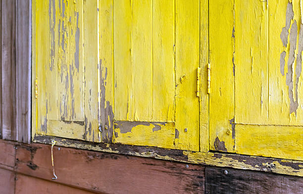 Peeling yellow painted wood combined with aged timber, creating a rustic vintage texture. Ideal for backgrounds and natural, distressed design themes