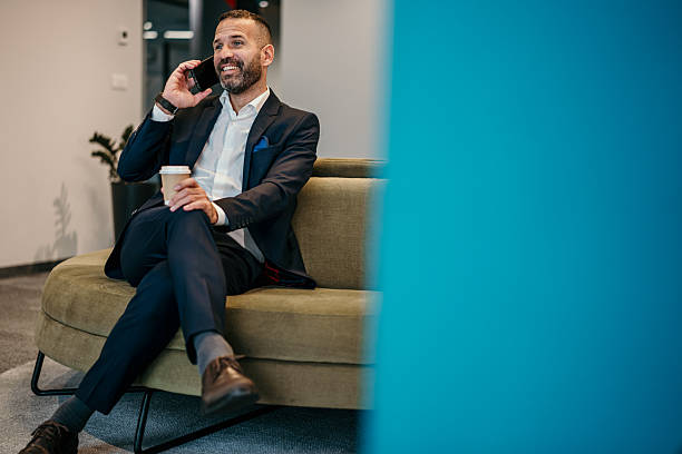 istock Businessman talking on phone enjoying coffee break 2250679278