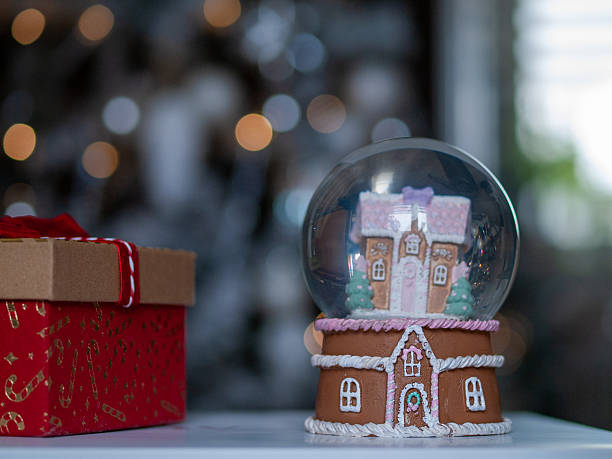 istock Decorative holiday ornament, Charming gingerbread snow globe featuring muted tones and tactile textures 2250679990