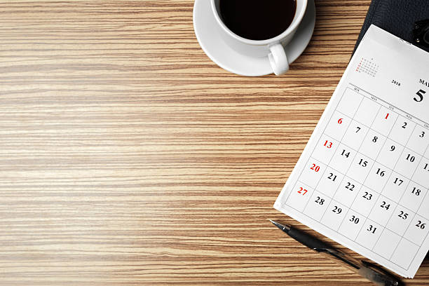istock Calendar and coffee cup on a wooden desk during a morning work session 2250680277