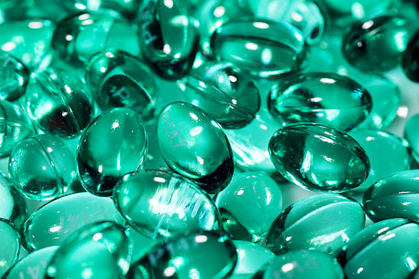 istock Blue capsules in the shell with liquid vitamin. Blue capsules with a dietary supplement for joints teeth and bones 2250681890