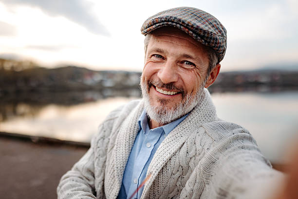 istock Mature man taking selfie near lake 2250682842