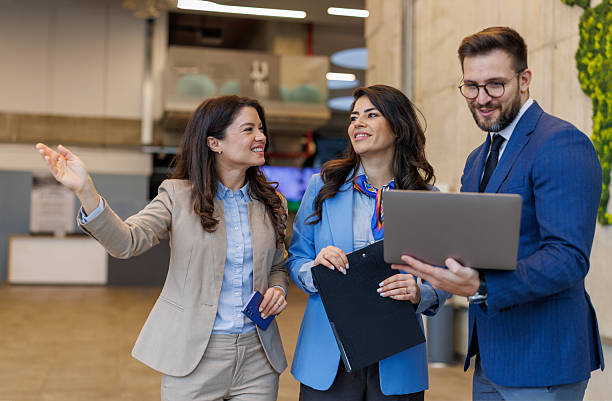 istock Business professionals discussing project during office walk 2250683154