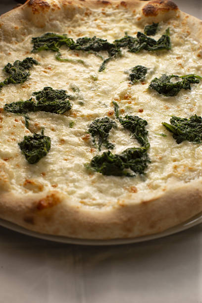 istock white pizza topped with spinach and ricotta, vegetarian feature 2250683595