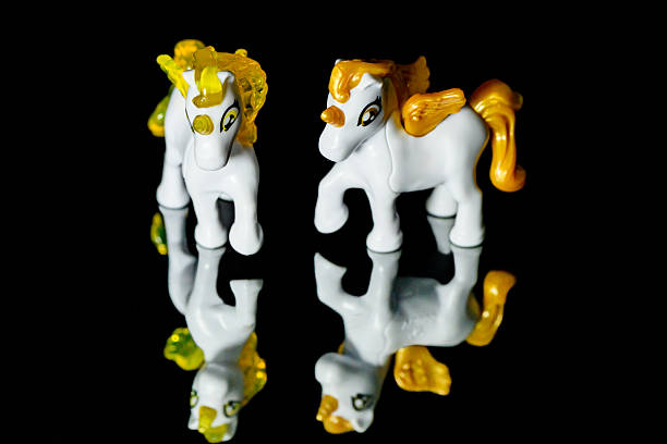 Unicorn toy on black glass