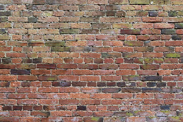 istock Traditional red brick wall with bricks aged by weathering 2250683885
