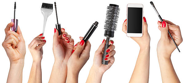istock Various hands holding beauty tools and a smartphone for makeup application and styling 2250684164