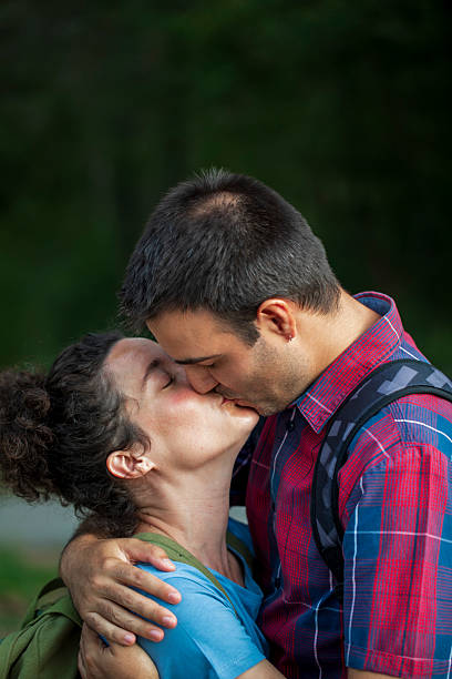 Kissing each other. Lovely couple are on the agricultural field together.