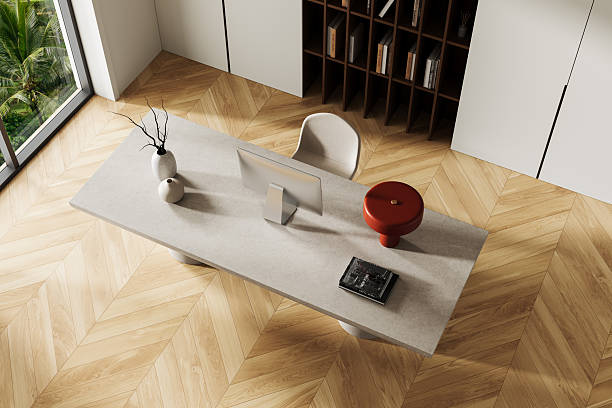 istock Modern minimalist workspace interior with concrete desk and red lamp in top view perspective, surrounded by light wood flooring and large window. 3D Rendering 2250685614