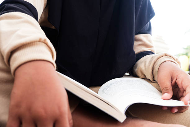istock Close-Up Shot of a Child Reading a Book 2250687539