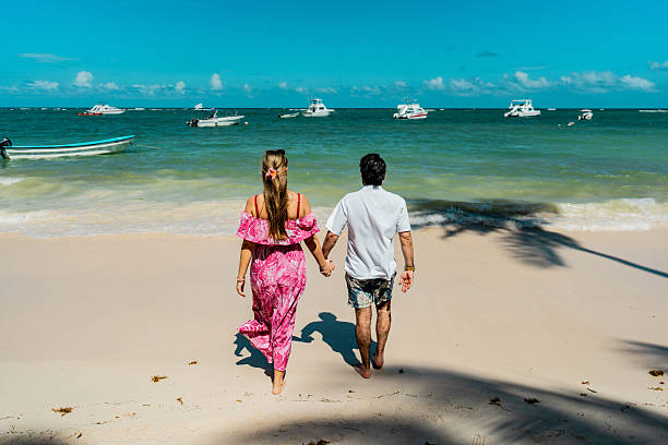 Couple walking through the beach in Punta Cana, Dominican Republic