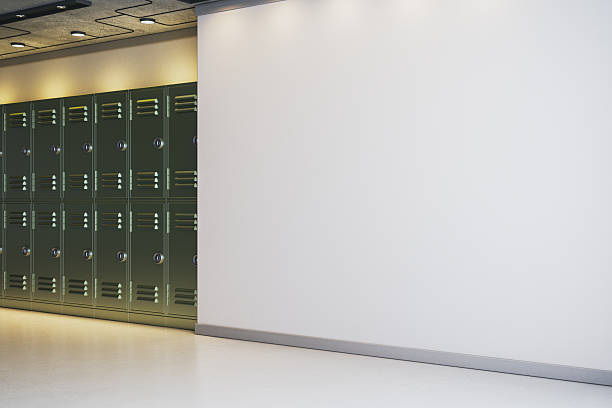 istock Blank white wall with copyspace next to dark green lockers in modern interior hallway under ceiling lights for poster or logo mockup placement. 3D Rendering 2250688876