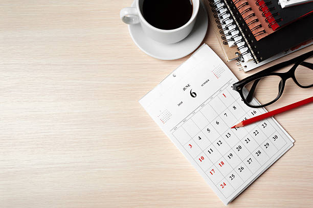istock Planning a productive day with a calendar, coffee, and notebooks on a workspace 2250691319