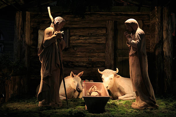Old figurine Baby Jesus in his crib from above on white background