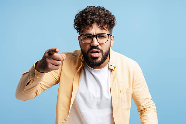 Upset man shouting, feeling frustrated and showing accusation, having a confrontation