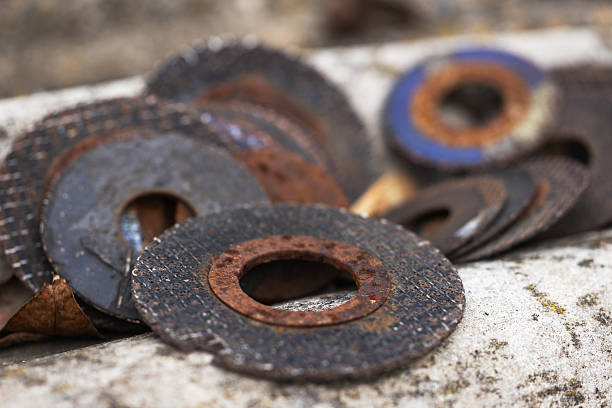 istock Old cutting discs for grinder tool, circular metallic discs with hole in center exposed to moisture or environmental condition 2250697021