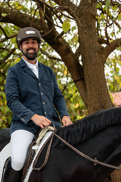 istock vertical Confident male equestrian rider smiling on horseback 2250697467