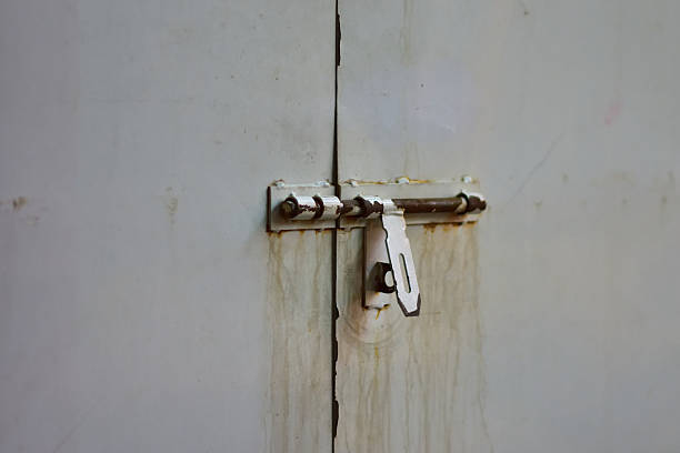 istock Rusty Metal Latch on White Door 2250697541