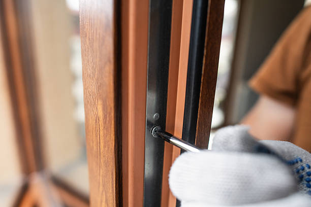 istock Man with screwdriver repairing window 2250704466