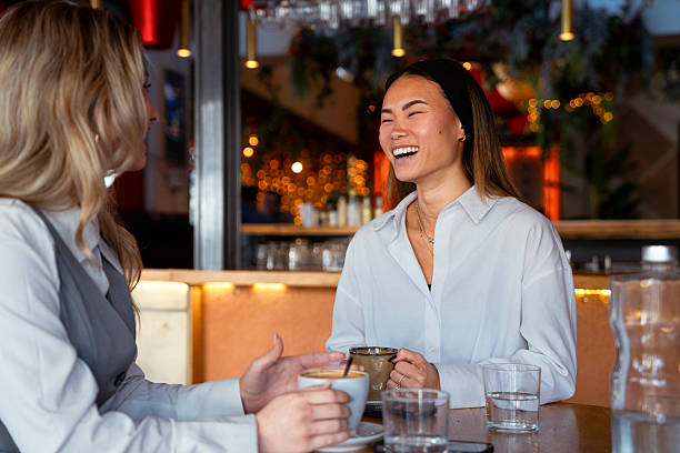 istock Girls chatting and drinking coffee in cafe 2250705072