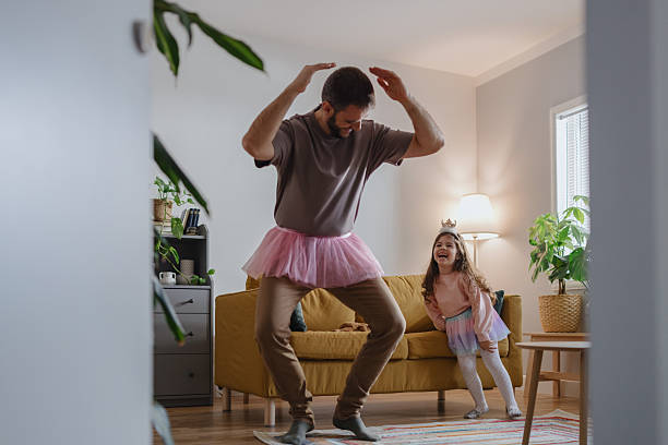 istock Little Daughter Teaching Father Ballet at Home 2250705482