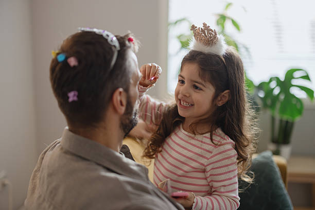 istock Playful Makeup Session Between Father and Daughter 2250706748