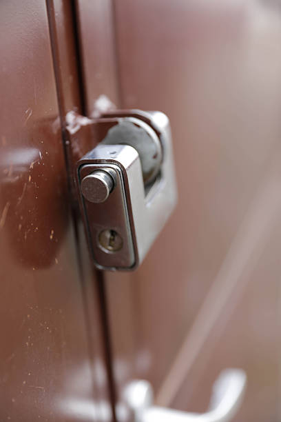 A Close-Up Of An Unlocked Metal Latch On A Weathered Door, Symbolizing Access, Vulnerability, Entry, And The Absence Of Security.