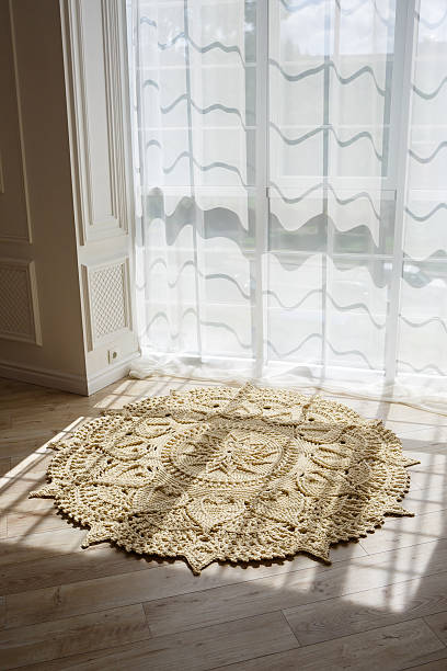 istock Handmade carpet knitted from natural threads, flooring, natural cotton. Beige handmade carpet. Interior solution for a house or apartment 2250709070